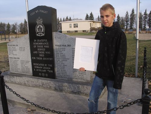 Canstar Community News Oct. 31, 2013 - Domain Grade 6 student Nicholas Enns shows his poem entitled Lest We Forget that won an award through the Royal Canadian Legion. (ANDREA GEARY/CANSTAR COMMUNITY NEWS)
