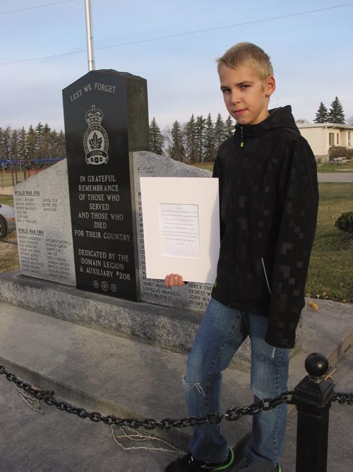 Canstar Community News Oct. 31, 2013 - Domain Grade 6 student Nicholas Enns shows his poem entitled Lest We Forget that won an award from the Royal Canadian Legion.(ANDREA GEARY/CANSTAR COMMUNITY NEWS)