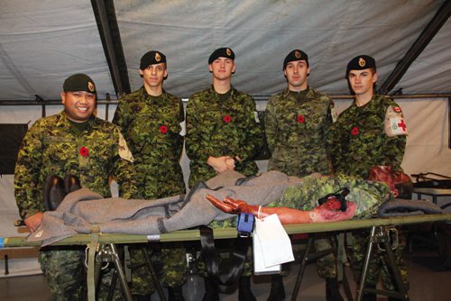 Canstar Community News To celebrate its 100th anniversary, the Minto Armoury hosted an open house on Saturday, complete with tours, displays and souvenirs for visitors.  From left: Sgt. Jeff Daquigan, Pte. Eldon Sinclair, Pte. Nick Petuhoff, Mcpl. Steven Kulbaba and Pte. Tom Denysenko of 17 Field Ambulance toured visitors through a display of a medical facility that would be the first line of medical care from the battlefield. (JORDAN THOMPSON)