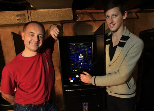 At left, Richard Naherny and Tim Schaubroeck with Tim and Rick's Custom Arcades & Pinballs Sales and Servive  builds stand-up video games and pinball machines from scratch and delivers them around town. The classic game Pac-Man is on the screen. Geoff Kirbyson story  Wayne Glowacki / Winnipeg Free Press Nov. 6. 2013