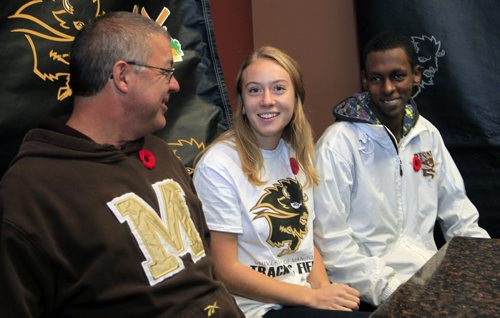 At left, University of Manitoba Bison cross country head coach Claude Berube with Womens cross country runner Rebekah Sass and Mens cross country runner Abduselam Yussuf at a press conference Wednesday  regarding competing at the 2013 CIS Cross Country Championship in London, ON (Western Ontario). Melissa Martin story  Wayne Glowacki / Winnipeg Free Press Nov. 6. 2013