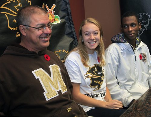 At left, University of Manitoba Bison cross country head coach Claude Berube with Womens cross country runner Rebekah Sass and Mens cross country runner Abduselam Yussuf at press conference Wednesday  regarding competing at the 2013 CIS Cross Country Championship in London, ON (Western Ontario). Melissa Martin story  Wayne Glowacki / Winnipeg Free Press Nov. 6. 2013