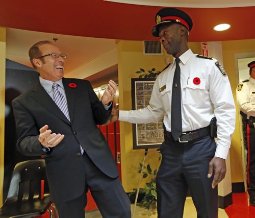 The Long Srnm Of the Law - Sam Katz  and  Police CHief Devon Clunis share a laugh after  newser - Wpg Police Chief Devon Clunis  gets congrats by Premier Greg Selinger , and Sam Katz  at the Ma Mawi Wi Chi Itata Centre  of the Urban Circle Training Centre. The Province of Mb , City of Wpg launch a 3 year  21 block radius crime , $600,000 prevention initiative , providing police at support for the neighborhood .  Nov. 6 2013 / KEN GIGLIOTTI / WINNIPEG FREE PRESS