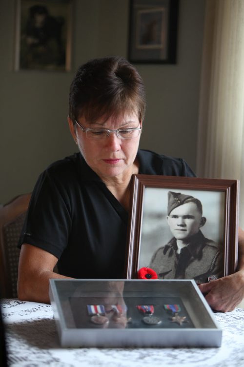 Mae Gulewich, whose father was one of the 29 men on   block on Dufferin Avenue in Selkirk who had enlisted at one time in the Second World War, thought to be a record.  Mae Gulewich, with a picture of her father and his medals in her home in Selkirk.  See Bill Redekop's story.  November 06,,  2013 Ruth Bonneville / Winnipeg Free Press