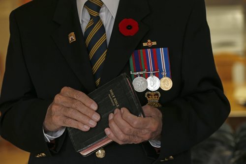 WINKLER- Harvey Friesen came from a Mennonite family , but did not consider himself very religious at the time , volunteered to go to WW2 looking for adventure ,at age 16  when he returned was he was against  the idea of apologizing in front of the congregation for his military service and chose to be married in his wifes  non Mennonite church - Mennonite Veteran  Harvey Friesen  for Randy Turner story on Mennonite Vets who chose to serve their country. Others  were  shunned by their church when they returned from WW2. Winkler vet Harvey Friesen  with Bible and  service medals . He was too young to fight and the war ended before he was 18 , so he never left CanadaHe is believed to be the last living member  from  that  group. Remembrance Day Feature by randy turner .
Nov. 6 2013 / KEN GIGLIOTTI / WINNIPEG FREE PRESS
