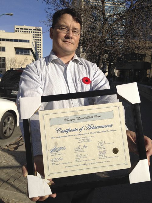 Shane Barratt, 44, is the first-ever graduate of the Winnipeg Mental Health Court, an innovative justice measure aimed at diverting people with mental illnesses who clash with the law away from the standard court process and into a tailored treatment regime. He's seen holding his certificate. Photo taken Nov. 7, 2013. James Turner / Winnipeg Free Press