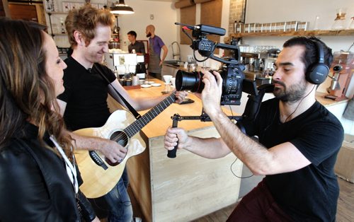 Chris Gaudry films singers Keith Macpherson and Renee Lamoureux in the Thom Bargen coffee shop on Sherbrook Avenue Thursday morning. Chris Gaudry is an independent videographer who shoots one-take videos of bands and artists in spots all over town - on the bus, in back alleys, etc. He then posts the videos on his YouTube channel - PocketGigs. 131108 - November 8, 2013 MIKE DEAL / WINNIPEG FREE PRESS