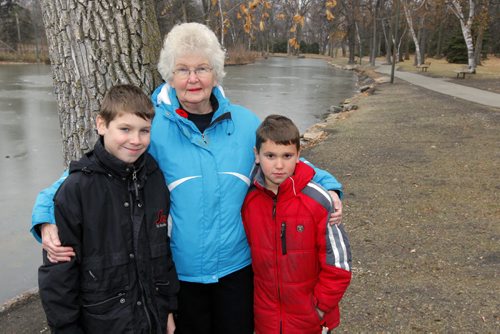 Jacob and Andrew DeBlaere stand with their grandmother Kathy Lesyk in St. Vital Park. There is alot of goose poop there and they want something done about it. BORIS MINKEVICH / WINNIPEG FREE PRESS  November 8, 2013