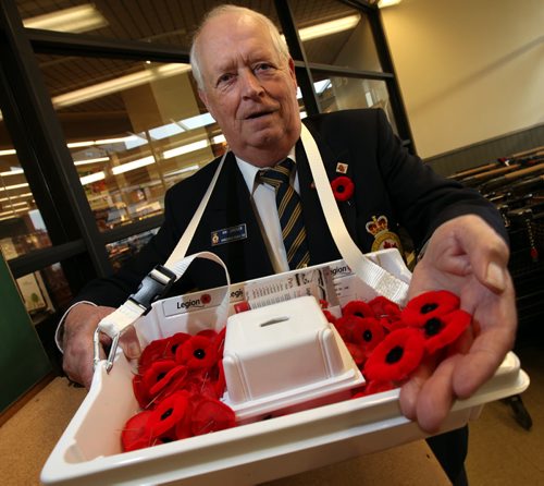 Hans Jorgenson sells poppies at the Tuxedo Village Safeway Friday.  See story. November 8, 2013 - (Phil Hossack / Winnipeg Free Press)