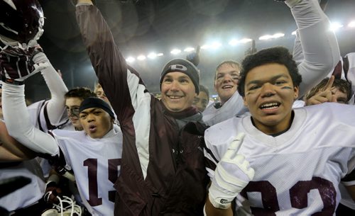 Calvin Diaz, head coach Peter Pura and Trevor Wright, members of the St.Paul's Crusaders AA football team celebrating their Free Press Bowl Championship victory over the Garden City Fighting Gophers by a score of 32-0 at Investors Group Field, Friday, November 8, 2013. (TREVOR HAGAN/WINNIPEG FREE PRESS)