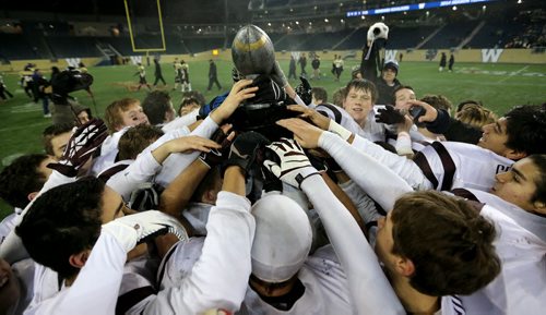 The St.Paul's Crusaders AA football team celebrates their Free Press Bowl Championship victory over the Garden City Fighting Gophers by a score of 32-0 at Investors Group Field, Friday, November 8, 2013. (TREVOR HAGAN/WINNIPEG FREE PRESS)