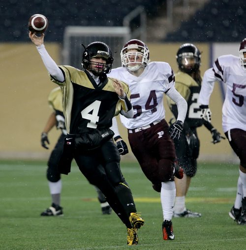 Garden City Gophers quarterback, Justin Casper is chased by St.Paul's Crusaders AA  Bradley Buckle during the second half of the Free Press Bowl Championship at Investors Group Field, Friday, November 8, 2013. (TREVOR HAGAN/WINNIPEG FREE PRESS)