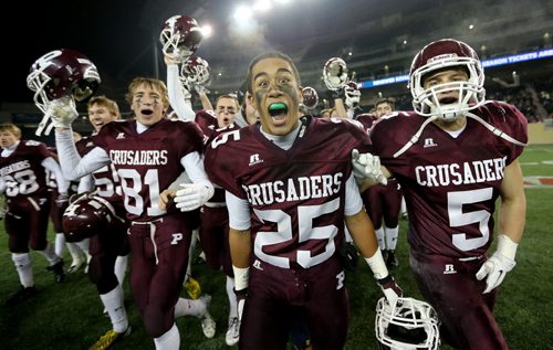 Matt MacDonald (81), Cody Cranston (21) and Teagan Horton (5), of the St.Paul's Crusaders AAA football team, celebrating their Anavet Cup victory over the Murdoch McKay Clansmen by a score of 56-8 at Investors Group Field, Friday, November 8, 2013. (TREVOR HAGAN/WINNIPEG FREE PRESS)