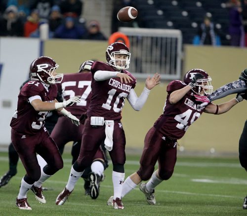 St.Paul's Crusaders AAA football team quarterback, Drake Lesperance (10) fires a pass during the second half of the teams Anavet Cup victory over the Murdoch McKay Clansmen by a score of 56-8 at Investors Group Field, Friday, November 8, 2013. (TREVOR HAGAN/WINNIPEG FREE PRESS)