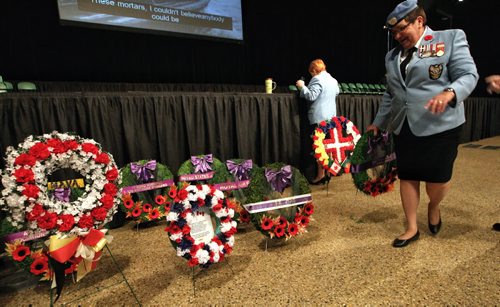 Linda Jardine from the Canadian Association of Veterans of the United Nations Peace Keepers organizes the wreaths prior to the start of the Remembrance Day Ceremonies at the RBC Convention Centre Monday morning.   131111 November 11, 2013 Mike Deal / Winnipeg Free Press
