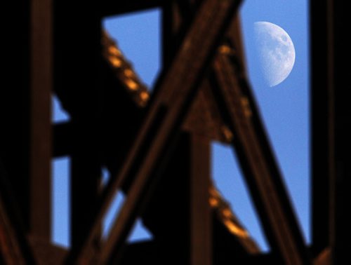 The moon seen through the train bridge near Waterfront Drive, Sunday, November 10, 2013. (TREVOR HAGAN/WINNIPEG FREE PRESS)