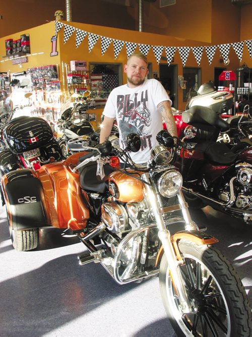 Canstar Community News Nov. 6, 2013 - Josh Kapitan shows off one of the custom conversion done at Griffin Trikes, that he and his father Tim own. (ANDREA GEARY/CANSTAR COMMUNITY NEWS)