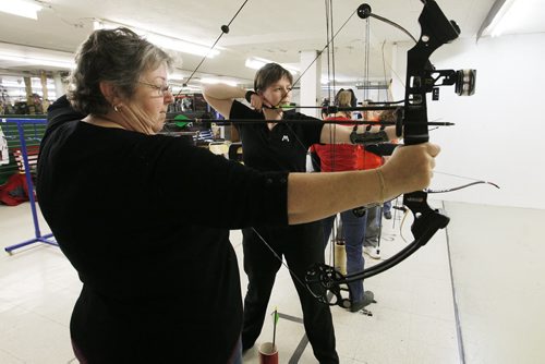 November 1, 2013 - 131101  -  (L to R) Karen Brownlee and Colby Sabourin take aim at The Heights Archery centre Friday, November 1, 2013. Bows, Broads and Bullseyes - a brand new, all-women archery group - gathers at the Heights on Friday nights to take dead aim at balloons, targets, you name it. Skill level ranges from beginner to competitive. John Woods / Winnipeg Free Press