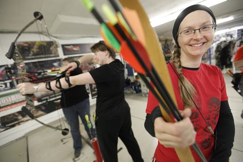 November 1, 2013 - 131101  -  (L to R) Heather Zueff shows off her arrows as (L to R) Colby Sabourin and Karen Brownlee take aim at The Heights Archery centre Friday, November 1, 2013. Bows, Broads and Bullseyes - a brand new, all-women archery group - gathers at the Heights on Friday nights to take dead aim at balloons, targets, you name it. Skill level ranges from beginner to competitive. John Woods / Winnipeg Free Press