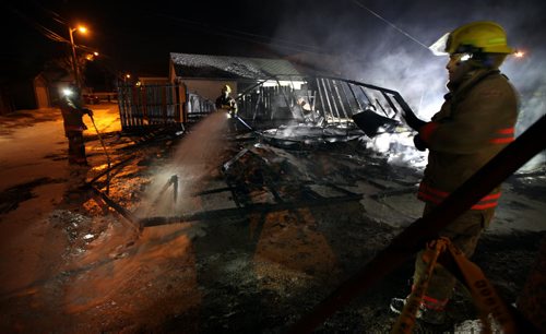 City firefighters douse a garage fire in the 900 block of Mountain ave Wednesday evening. See Ashley Prest tale. November 13, 2013 - (Phil Hossack / Winnipeg Free Press)