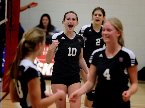 Left to right, Westwood Warrior #10 Katie Hamm,and her team mates celebrate a point against the Vincent Massey Trojans Wednesday afternoon at the WWAC Volleyball Playoffs. November 13, 2013 - (Phil Hossack / Winnipeg Free Press)