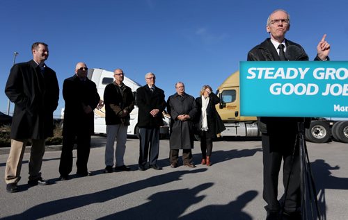 At an announcement regarding the upgrade of Highway 75, Minister Steve Ashton speaks at the podium and is flanked by, from left, Brad Chase, VP Bison Transport, Bob Dolyniuk, executive director of the Manitoba Trucking Association, Gavin van der Linde, Mayor of Morris, Premier Greg Selinger, Chris Lorenc, President of the Manitoba Heavy Construction Association, and Diane Gray, CEO of CentrePort Canada, Wednesday, November 13, 2013. (TREVOR HAGAN/WINNIPEG FREE PRESS)