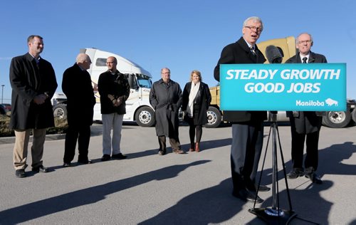 At an announcement regarding the upgrade of Highway 75, Premier Greg Selinger and Minister Steve Ashton speak at the podium and are flanked by, from left, Brad Chase, VP Bison Transport, Bob Dolyniuk, executive director of the Manitoba Trucking Association, Gavin van der Linde, Mayor of Morris, Chris Lorenc, President of the Manitoba Heavy Construction Association, and Diane Gray, CEO of CentrePort Canada, Wednesday, November 13, 2013. (TREVOR HAGAN/WINNIPEG FREE PRESS)