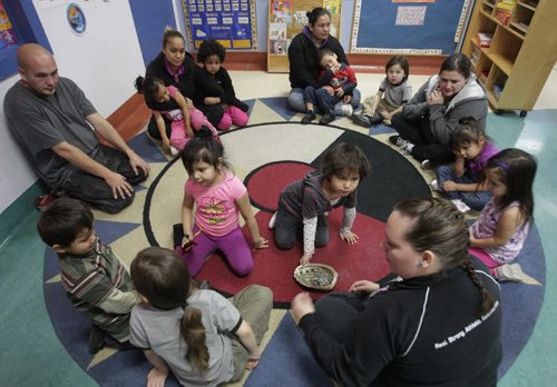 In centre right, Madison and Miley with an eagle feather move the smudge around circle during the Little Red Spirit Aboriginal Head Start Program at 185 Young St. Mary Agnes Welch story   Wayne Glowacki / Winnipeg Free Press Nov. 14. 2013