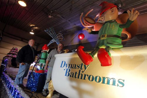 A sneak peak of the Dynasty Bathrooms float. It is the third year that Dynasty has done a float.  A giant bathtub filled with reindeer, elves fishing, and audio with music on float. Eugene Boyechko,L,  longtime friend of Ken Onsowich,R, owner of Dynasty Bathrooms pose for a photo. BORIS MINKEVICH / WINNIPEG FREE PRESS  November 14, 2013