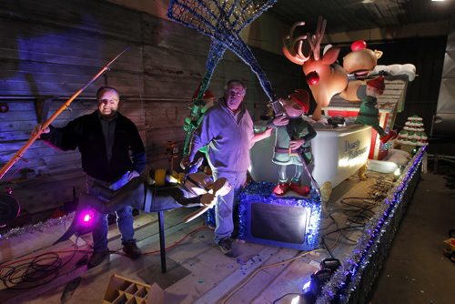 A sneak peak of the Dynasty Bathrooms float. It is the third year that Dynasty has done a float.  A giant bathtub filled with reindeer, elves fishing, and audio with music on float. Eugene Boyechko,L,  longtime friend of Ken Onsowich,R, owner of Dynasty Bathrooms pose for a photo. BORIS MINKEVICH / WINNIPEG FREE PRESS  November 14, 2013