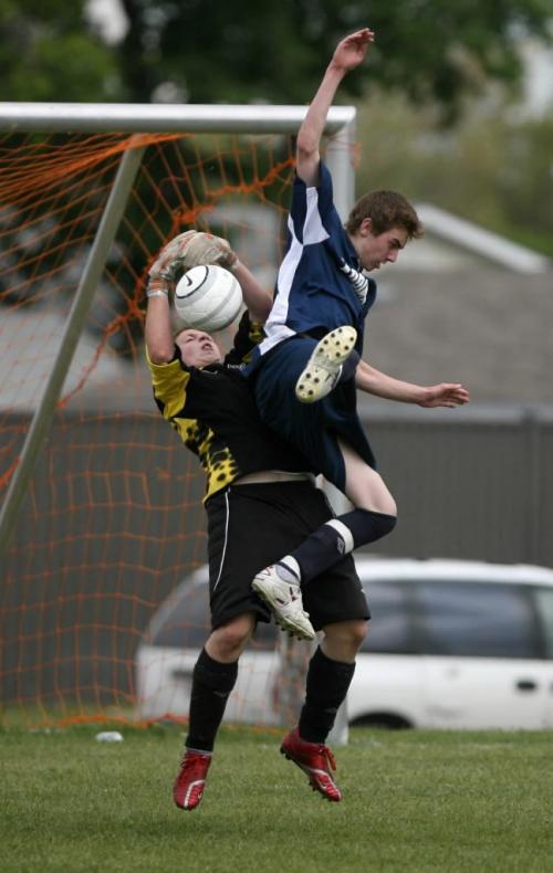 MIKE DEAL / WINNIPEG FREE PRESS 070602 June 02, 2007 Goalie Scott Smoke of the Oak Park Raiders stops the ball while River East Kodiaks, Brandon Le Grand tries to deflect it with his head during a soccer game Saturday afternoon. See Allan Besson story.