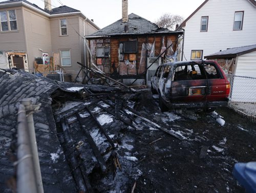 Stdup - Garage /house fire destroyed a detached garage , a vehicle and heavily damaged  house at 1650 Alexander Ave . Nov. 15 2013 / KEN GIGLIOTTI / WINNIPEG FREE PRESS
