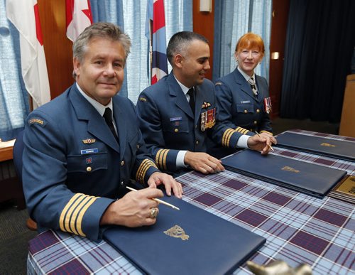 Former Blue Bomber (left) Trevor Kennerd  was named Honorary Colonel  of 435 Transport and Rescue Squadron  at a ceremony presided over by (centre)  Lt.Col.  Steve Lamarche  435 Squadron  Commanding Officer  ,held at CFB Winnipeg , he replaces outgoing (right) Honorary Colonel Loreena McKennitt Äì Kennerd played 12 seasons with the Blue Bomber winning 3 Grey Cups  Nov. 15 2013 / KEN GIGLIOTTI / WINNIPEG FREE PRESS