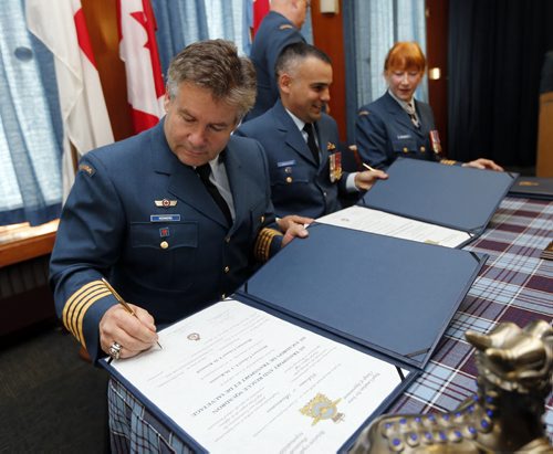 Former Blue Bomber (left) Trevor Kennerd  was named Honorary Colonel  of 435 Transport and Rescue Squadron  at a ceremony presided over by  (centre) Lt.Col.  Steve Lamarche  435 Squadron  Commanding Officer  ,held at CFB Winnipeg , he replaces outgoing (right) Honorary Colonel Loreena McKennitt Äì Kennerd played 12 seasons with the Blue Bomber winning 3 Grey Cups  Nov. 15 2013 / KEN GIGLIOTTI / WINNIPEG FREE PRESS