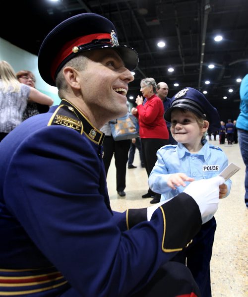 New Winnipeg Police Officer recruit James Gulash gets a warm welcome from his young three year old son Larson dressed in a police uniform after his graduation ceremony for recruit class #154 which took place at the Convention Centre Friday afternoon with 38 male and 4 female members. November 15, 2013 Ruth Bonneville / Winnipeg Free Press