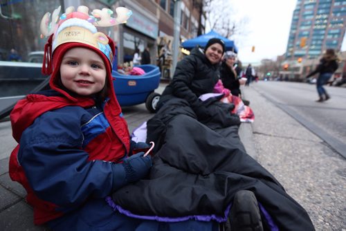 Madeline Dunton, 4, and her mom Sally, setup in a great location on Portage Avenue waiting for the Santa Claus parade, Saturday, November 16, 2013. (TREVOR HAGAN/WINNIPEG FREE PRESS)