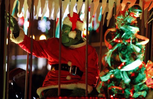 The Winnipeg Police Service have The Grinch locked up and on display during the  Santa Claus parade, Saturday, November 16, 2013. (TREVOR HAGAN/WINNIPEG FREE PRESS)