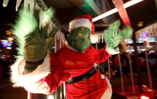 The Winnipeg Police Service had The Grinch locked up during the Santa Claus Parade on Portage Avenue, Saturday, November 16, 2013. (TREVOR HAGAN/WINNIPEG FREE PRESS)