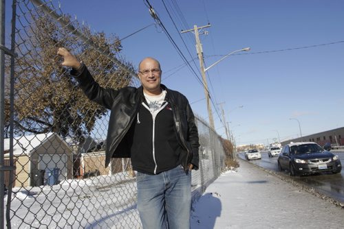 Alan Castell by the fence behind his home on Queen Street that runs along Century St. The Winnipeg  Chamber of Commerce wants to erect a wall along his back lane, part of a $7 million initiative to beautify the airport-to-downtown traffic route. Aldo Santin story   Wayne Glowacki / Winnipeg Free Press Nov. 18. 2013