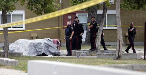 -crime scene with lawn chairs covered with tarp to protect from light early morning rain - Wpg City Police investigate fight  that occurred at Lord Selkirk Park  a  Man. Housing project common area  on Robinson St that left one person dead  KEN GIGLIOTTI / SEPT 20 2013 / WINNIPEG FREE PRESS