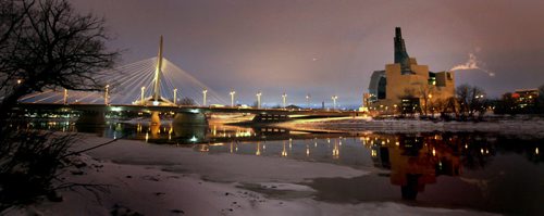 The Provencer Bridge and Museum for human RIghts reflect in open Red River water Monday evening at dusk....  November 18, 2013 - (Phil Hossack / Winnipeg Free Press) CMHR