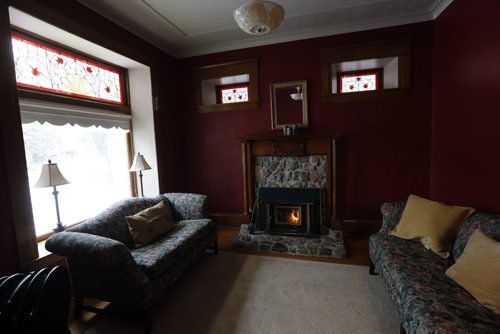 reading room with fireplace and stained glass windows and heavy wood & plaster detail - Historic Morden  Stephen St. stone home  is up for sale built in 1902 Äì bill redekop story  Nov. 19 2013 / KEN GIGLIOTTI / WINNIPEG FREE PRESS