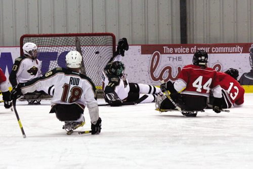Canstar Community News The Manitoba Falcons' Ian Dmytriw (#13) just manages to get the puck over Minnesota Wild goaltender Judd Yaeger and in the back of the net in the second period. (JORDAN THOMPSON)