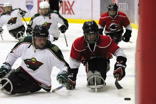 Canstar Community News The Minnesota Wild and Manitoba Falcons sledge hockey teams battle for the puck. (JORDAN THOMPSON)