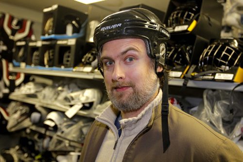 Marcus Malbasa trying on a hockey helmet. The story is about the Jets banning helmets to Chicago game tomorrow night to mock what that drunk guy did to Pardy in Chicago a few weeks ago. Marcus is a Jets fan who doesnt agree with the decision.. BORIS MINKEVICH / WINNIPEG FREE PRESS  November 20, 2013
