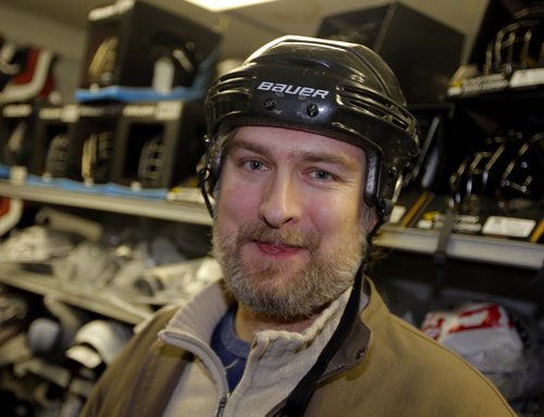 Marcus Malbasa trying on a hockey helmet. The story is about the Jets banning helmets to Chicago game tomorrow night to mock what that drunk guy did to Pardy in Chicago a few weeks ago. Marcus is a Jets fan who doesnt agree with the decision.. BORIS MINKEVICH / WINNIPEG FREE PRESS  November 20, 2013