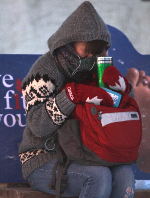 BRRRR!- A transit commuter waits for her bus clutching her warm drink on Academy Road Thursday morning  With the wind chill this morning in Winnipeg temperatures felt like -25 C-Standup photo- Nov 21,, 2013   (JOE BRYKSA / WINNIPEG FREE PRESS)