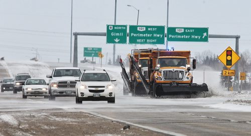 Snow clearing and sanding trucks work the McPhillips Street overpass at the Perimeter Highway Sunday morning.  131124 November 24, 2013 Mike Deal / Winnipeg Free Press