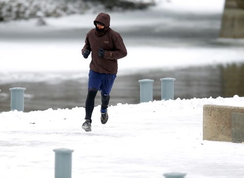 Brent Morden goes for an 11km run through the Forks. Mild temperatures are cast over Winnipeg. . BORIS MINKEVICH / WINNIPEG FREE PRESS  November 25, 2013