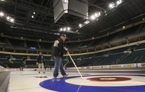 Renowned ice maker Hans Wuthrich floods the curling ice at the MTS Centre in Winnipeg Monday night in preparation for the Tim Hortons Roar of the Rings curling competition which will run December 1-8, 2013- The winner from mens and ladies rinks will represent Canada at the Sochi 2014 Winter Olympic Games Standup photo- Nov 25, 2013   (JOE BRYKSA / WINNIPEG FREE PRESS)